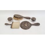 Silver-coloured dressing table mirror and matching brush profusely decorated with flowers, marked