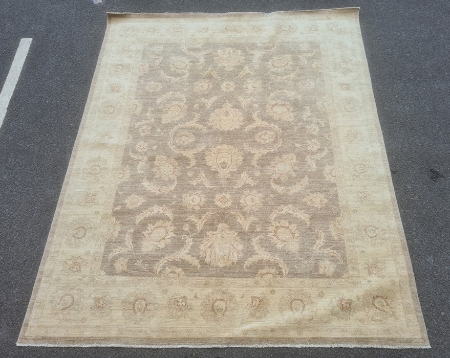 Large fawn ground rug with allover floral decoration, cream borders, 306cm x 242cm