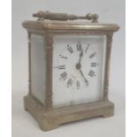 Brass and glass carriage clock with Roman numerals to the dial