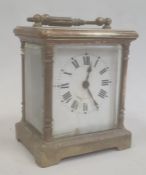 Brass and glass carriage clock with Roman numerals to the dial