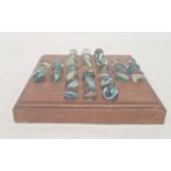 A 20th century marble solitaire board, square shaped with thirty two marbles