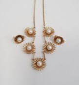 9ct gold necklace with five stylised flowerheads, each set with a central cultured pearl and a