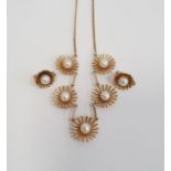 9ct gold necklace with five stylised flowerheads, each set with a central cultured pearl and a