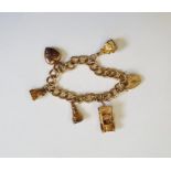 9ct gold charm bracelet, padlock clasp with five assorted charms including three fob seals, 43g in