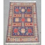 Modern Eastern-style rug, the blue ground field with nine octagonal motifs, in blues, reds,