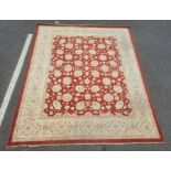 Modern Eastern-style rug, red ground with cream allover foliate decoration, cream ground border,