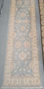 Modern Eastern-style duck egg blue ground foliate decorated rug with stepped border, 306cm x 79cm