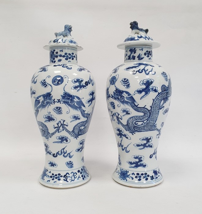 Pair Chinese porcelain vases, each inverse baluster shaped and painted with pair ferocious dragons