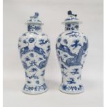 Pair Chinese porcelain vases, each inverse baluster shaped and painted with pair ferocious dragons