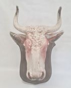 Painted polystyrene model of a cow's head, mounted on painted wood shield, 53cm high overall