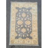Modern duck egg blue ground Eastern-style rug with foliate decoration to the central field, cream