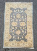 Modern duck egg blue ground Eastern-style rug with foliate decoration to the central field, cream