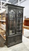 Early 20th century ebonised display cabinet, the leaded glazed doors enclosing shelves, two cupboard