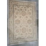 Modern cream ground rug with foliate decoration, 184cm x 126cm