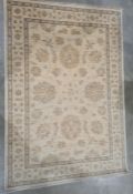 Modern cream ground rug with foliate decoration, 184cm x 126cm