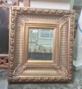 20th century rectangular mirror with bevel edged plate, heavy moulded frame, 52cm x 46cm and another