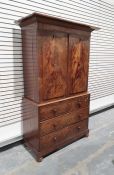 19th century mahogany linen press, the cornice above two doors enclosing linen shelves, the base