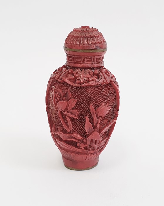 Chinese carved cinnabar lacquer snuff bottle, slender ovoid with panels of flowers, 6.5cm high,