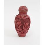 Chinese carved cinnabar lacquer snuff bottle, slender ovoid with panels of flowers, 6.5cm high,