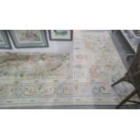 Modern cream ground rug in blues, peaches, yellows, greens and duck egg blue ground border, 280cm