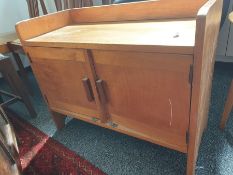 1920's Cotswold School-style low two-door cupboard with three-quarter gallery top above two cupboard