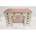 Early 20th century white painted pedestal desk, with campaign-style handles, 11 assorted drawers, on