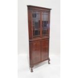 20th century walnut corner display cupboard with two astragal-glazed doors enclosing shelves, two