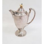 George V silver coffee pot with ivy finial and leaf relief decoration to handle, on circular base,
