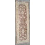 Modern Eastern-style brown ground runner with cream foliate decoration and cream ground border,