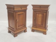 Modern cherrywood pair of bedside chests with single drawers above cupboard doors, to shaped feet (