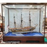 Painted wooden model of The Royal Yacht Caroline 1749, in glazed and stained wood table-top cabinet,