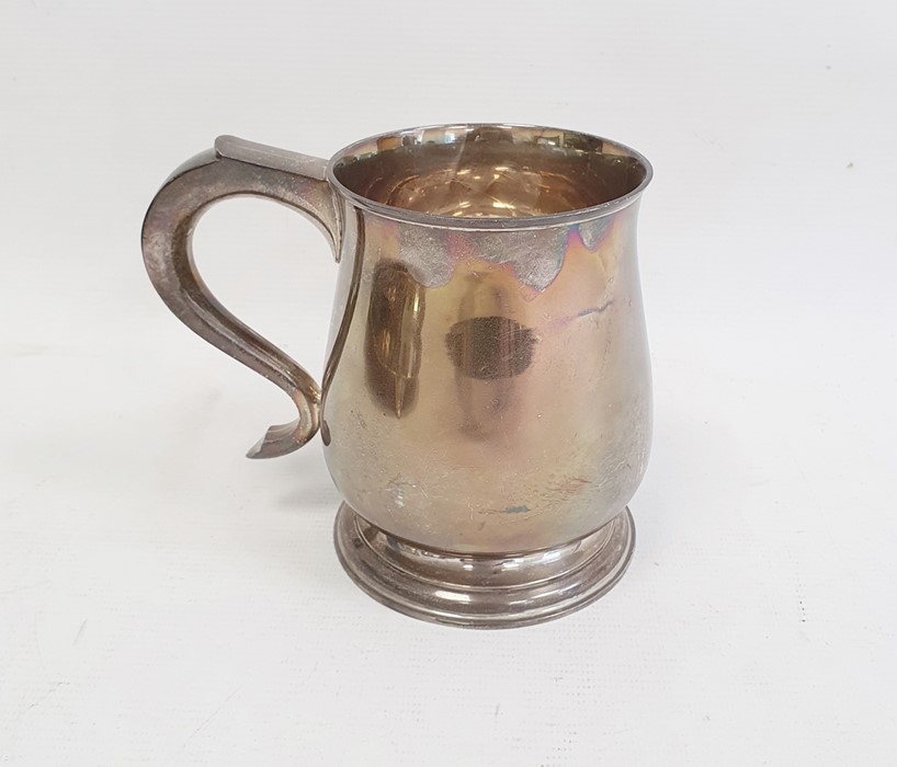 Silver mug by Wakely & Wheeler, London 1936 of plain baluster form, on circular foot with scroll