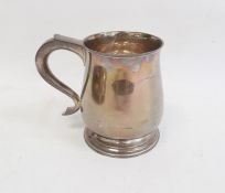 Silver mug by Wakely & Wheeler, London 1936 of plain baluster form, on circular foot with scroll