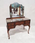 20th century dressing table with three-part mirror above the five assorted drawers, on cabriole legs