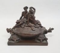 A 19th century bronze inkwell in the form of two nude classical figures seated atop Bixi, a dragon