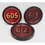 Set of three painted wood roundels, variously numbered in gilt on a red ground, 35cm dia.Condition