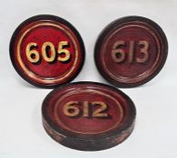 Set of three painted wood roundels, variously numbered in gilt on a red ground, 35cm dia.Condition