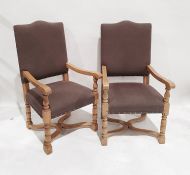 Pair of modern oak-framed armchair with brown upholstered seats and backs, wavy X-shaped stretchered