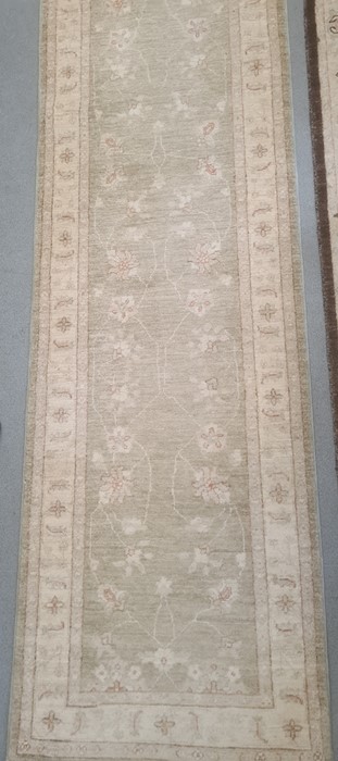 Modern Eastern-style pale sage ground foliate decorated rug, 295cm x 82cm