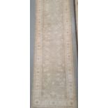 Modern Eastern-style pale sage ground foliate decorated rug, 295cm x 82cm