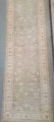 Modern Eastern-style pale sage ground foliate decorated rug, 295cm x 82cm