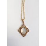 Gold-coloured metal and moonstone oval pendant set single stone in openwork filigree mount and the