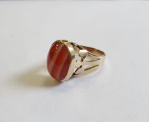 9ct gold ring set with a banded agate cabochon and with pierced trefoil shoulders, finger size M 1/