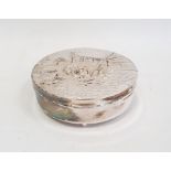 A 20th century silver coloured metal circular box, the lid relief decorated with figures in a