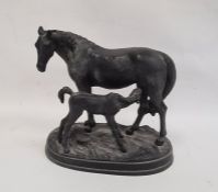 Black painted cast metal group of a mare and foal on oval plinth base, 23cm high