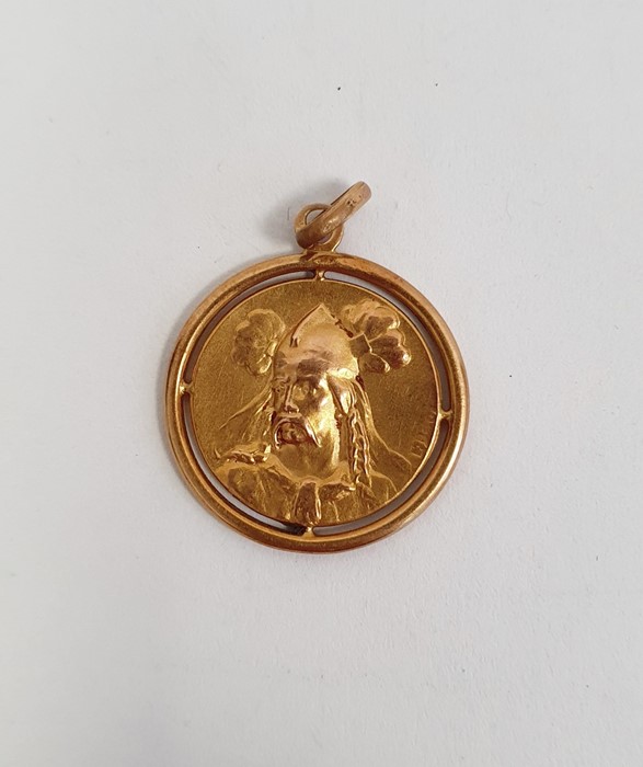 Gold-coloured pendant of circular form depicting a warrior, marks rubbed, approx 1.9g