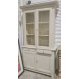 Grey painted bookcase cabinet with moulded cornice above two glazed doors enclosing shelves, two