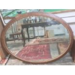 Late 19th/early 20th century oval mirror in rosewood-effect frame, 107cm x 85cm