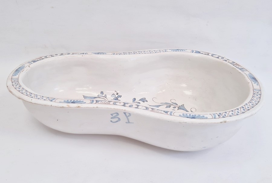 Nineteenth century tin-glazed earthenware bidet bowl in blue and white with floral scrolling