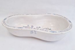 Nineteenth century tin-glazed earthenware bidet bowl in blue and white with floral scrolling